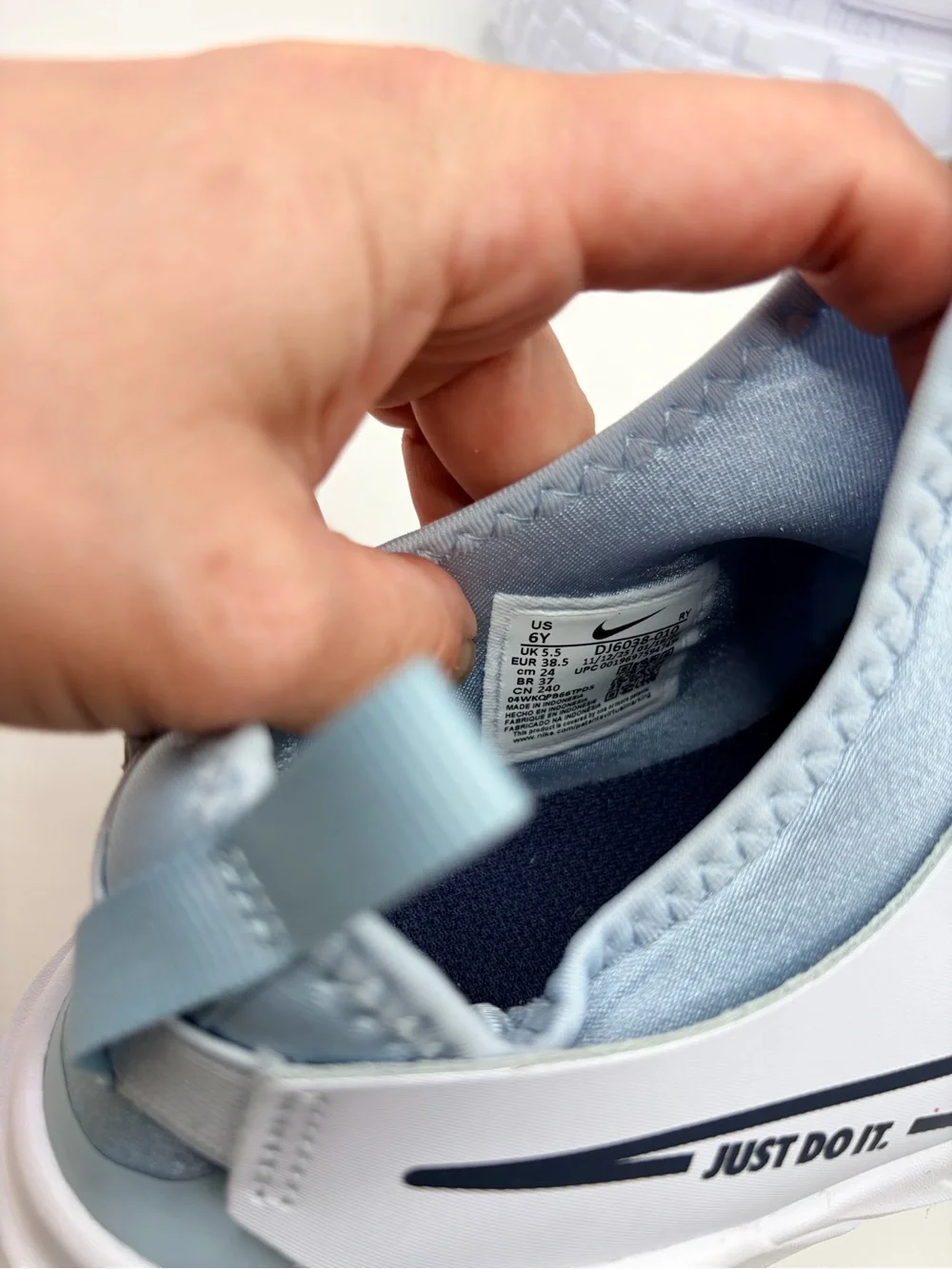 Nike 6Y/7.5W Light Blue and White Slip-On Sneakers with Navy Swoosh